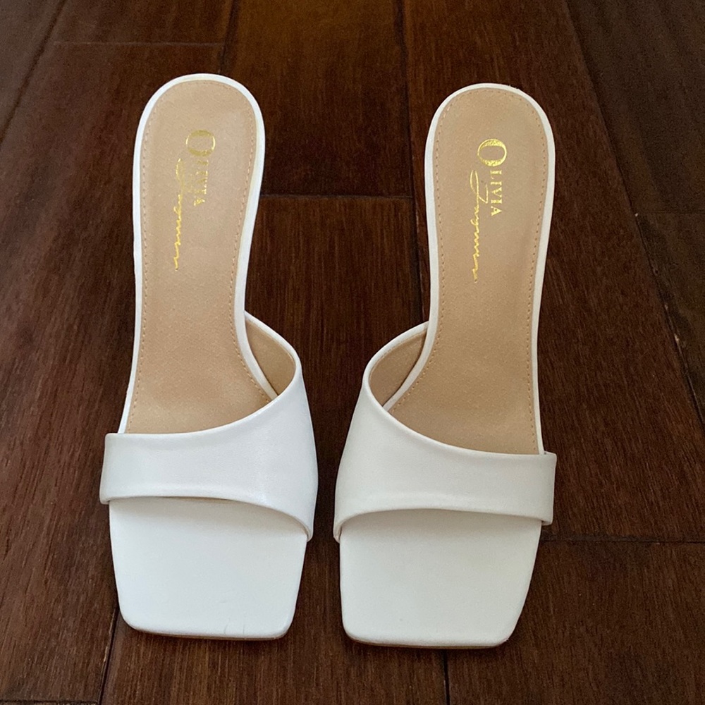 Brand new white high heels.